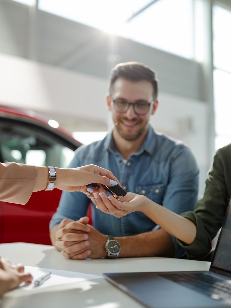 female customer receiving car keys shaking hands w RDW3NP2.jpg